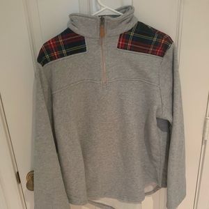Gray sweater with flannel shoulders.